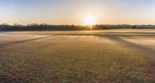 Beautiful foggy sunrise landscape in West Newton, Minnesota, USA, capturing autumn fields.